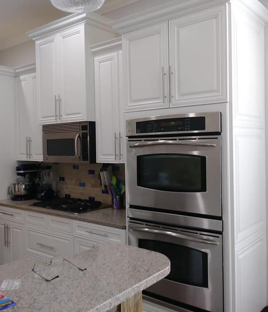 Kitchen with white painted cabinets and built-in ovens, Jacksonville FL