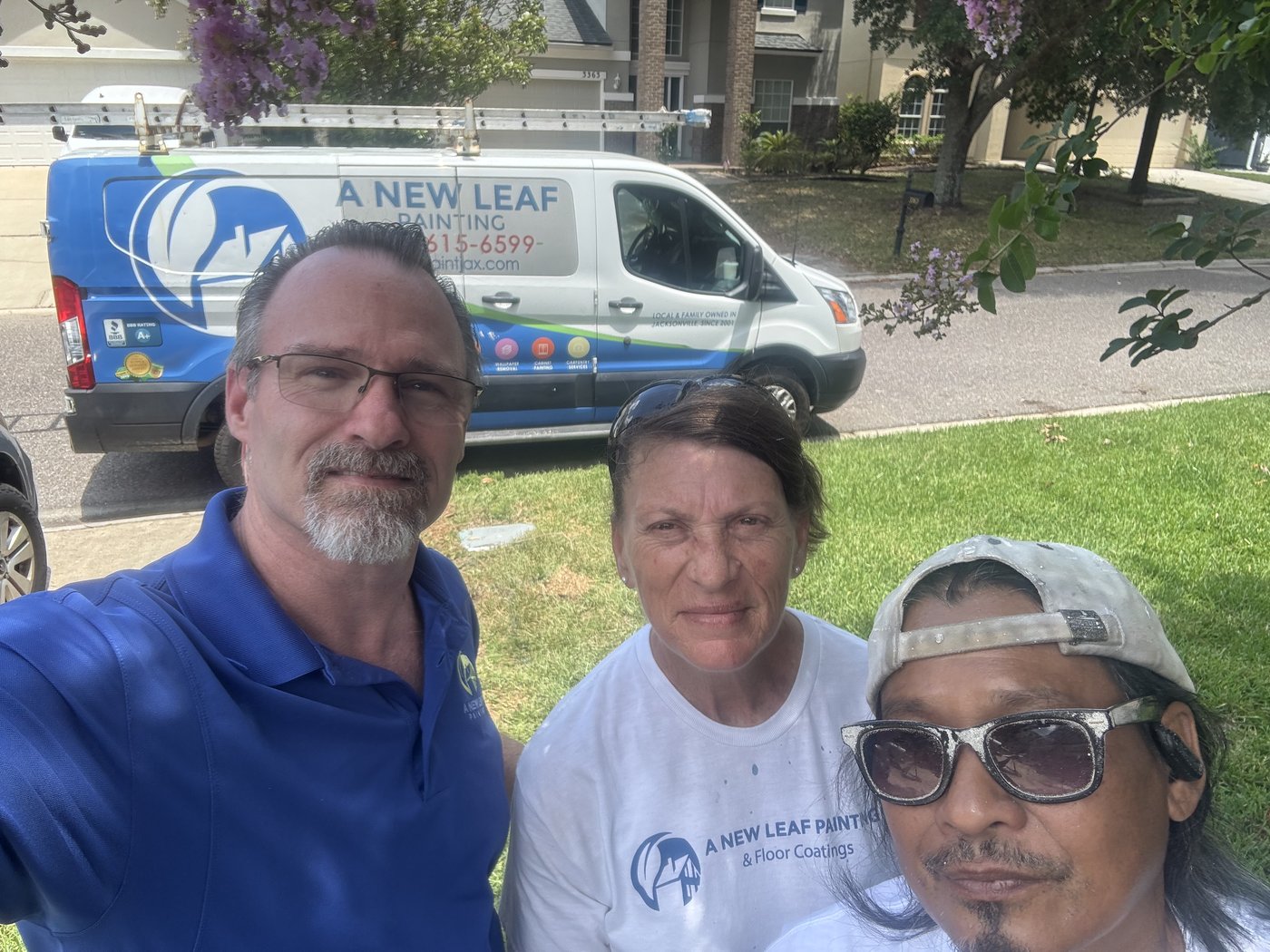 The owner with two of the A New Leaf crew in front of the company van