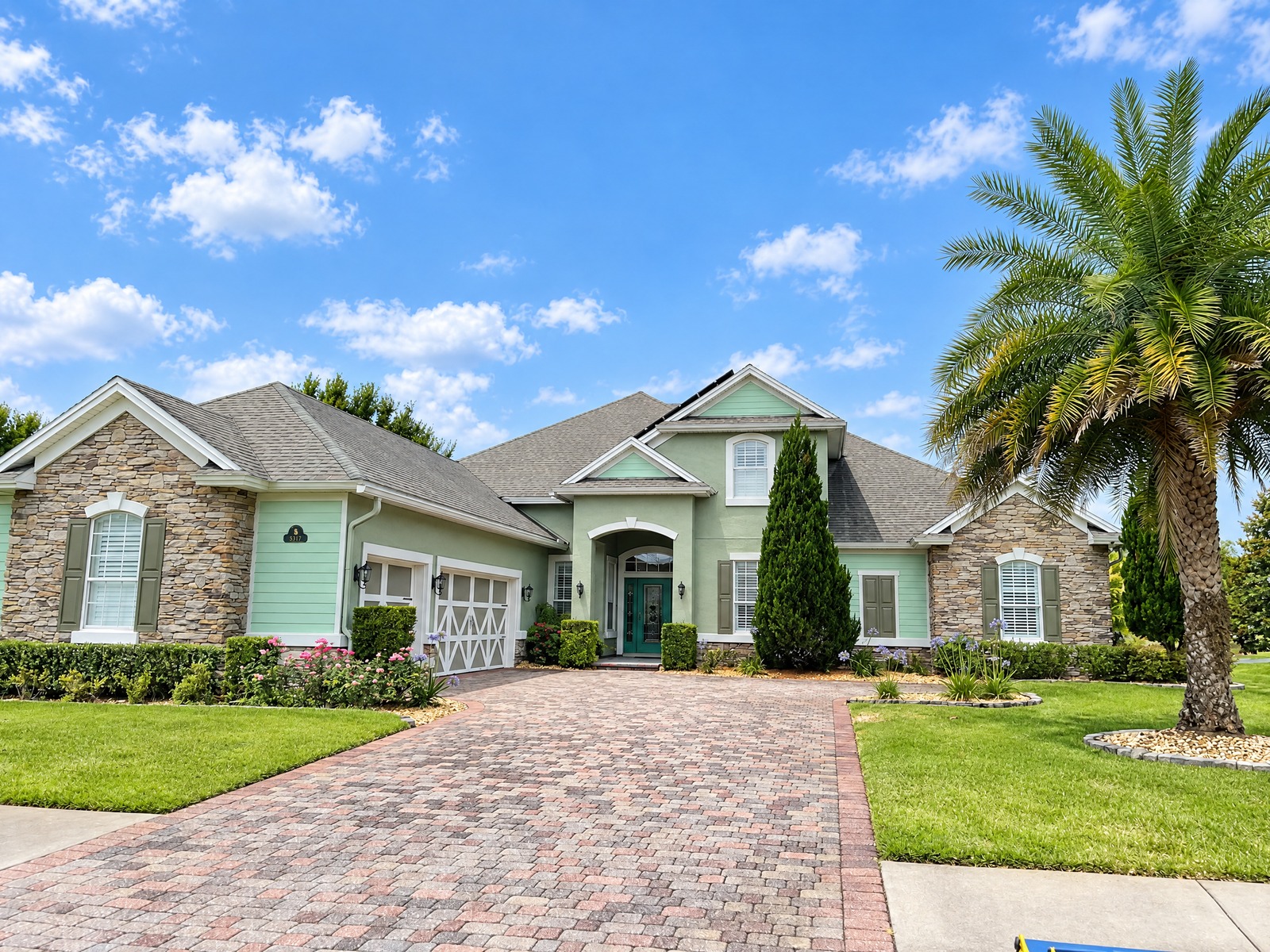 Two-storey home with stone and siding after exterior painting in Jacksonville, FL