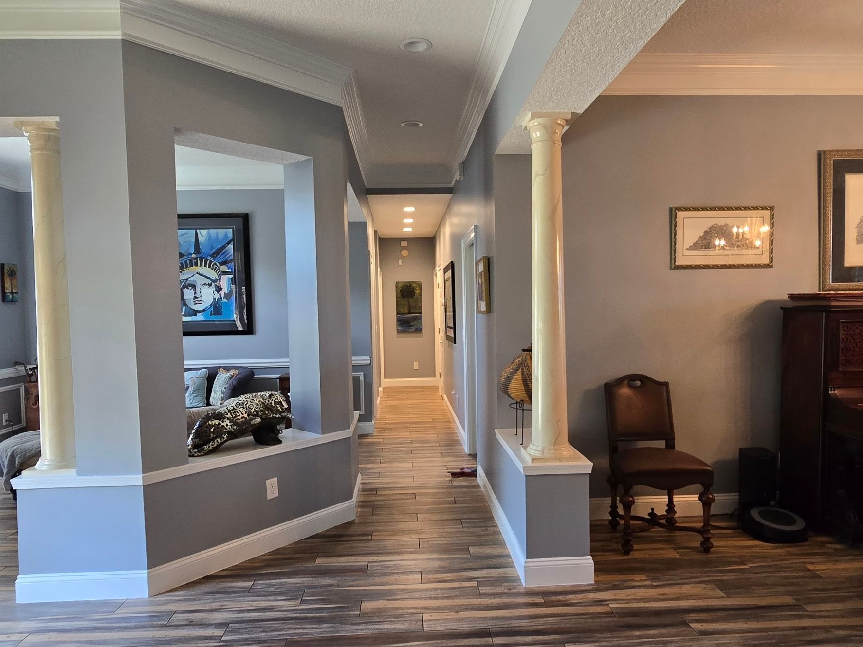 The same Queens Harbor entry and hallway after painting, grey walls and white columns and trim