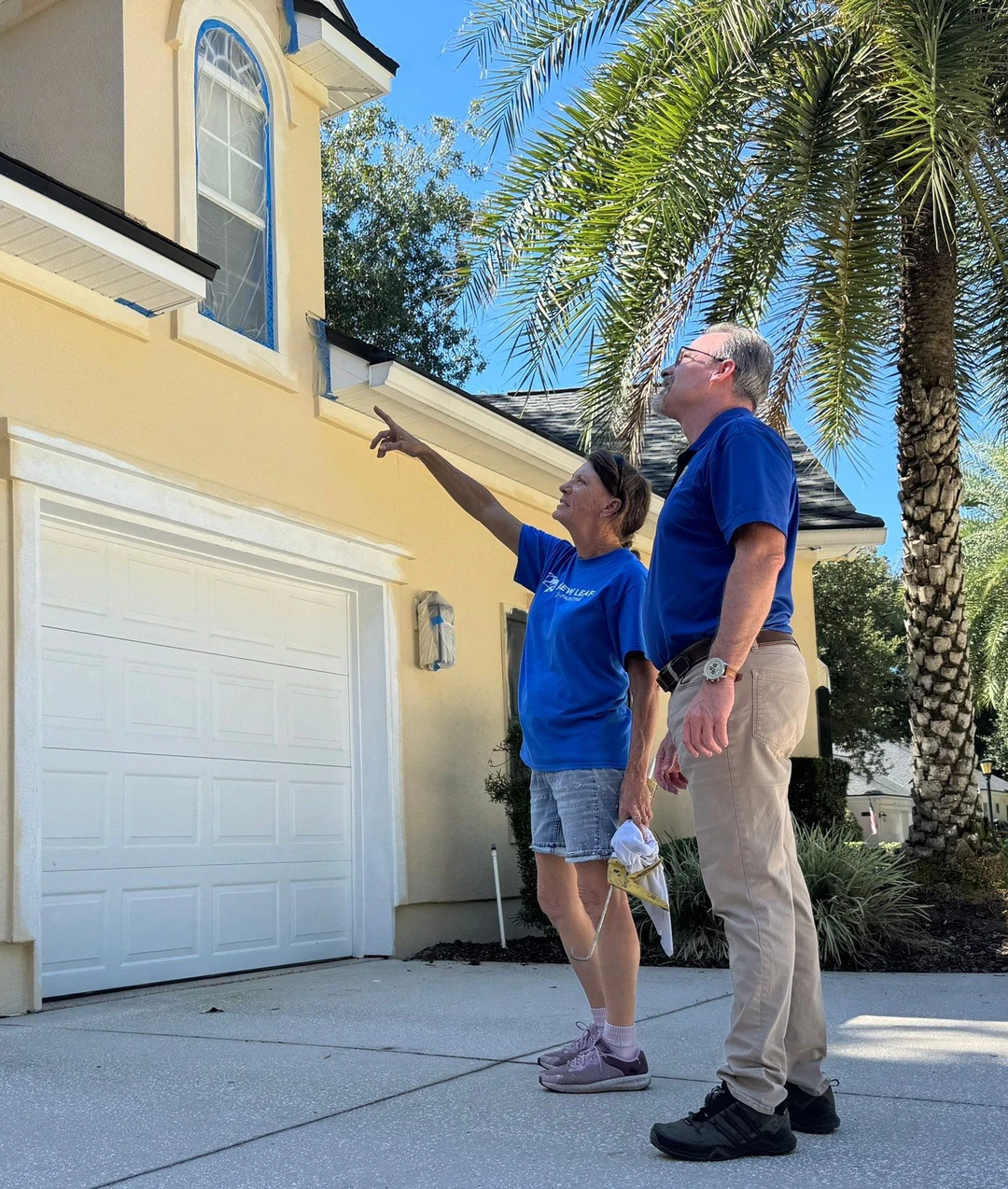 Checking the masking and prep on a stucco home before it is painted