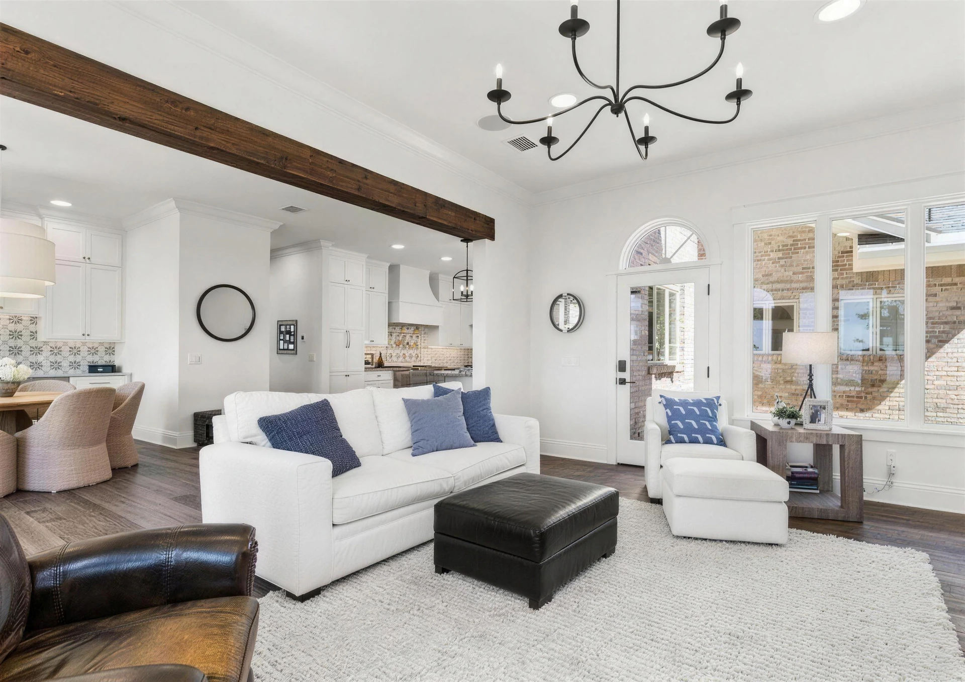 Great room after interior painting, white walls, wood beams and an open kitchen