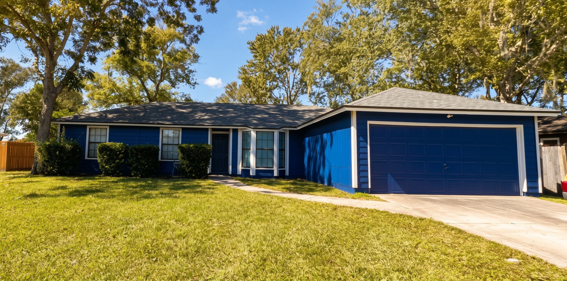 Middleburg, FL home after exterior wood repair and painting, blue siding and white trim