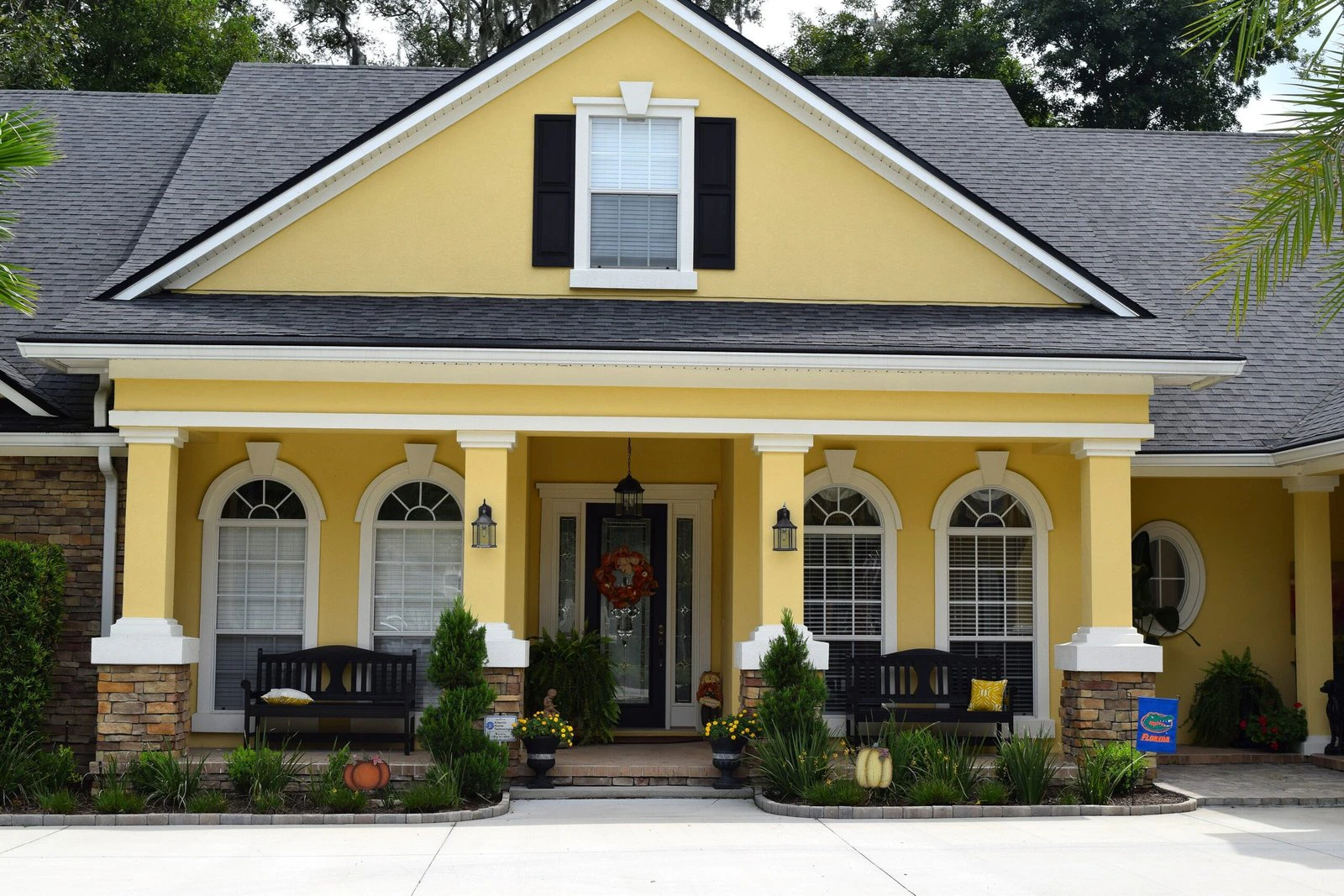 Yellow exterior with black shutters and white trim after repaint