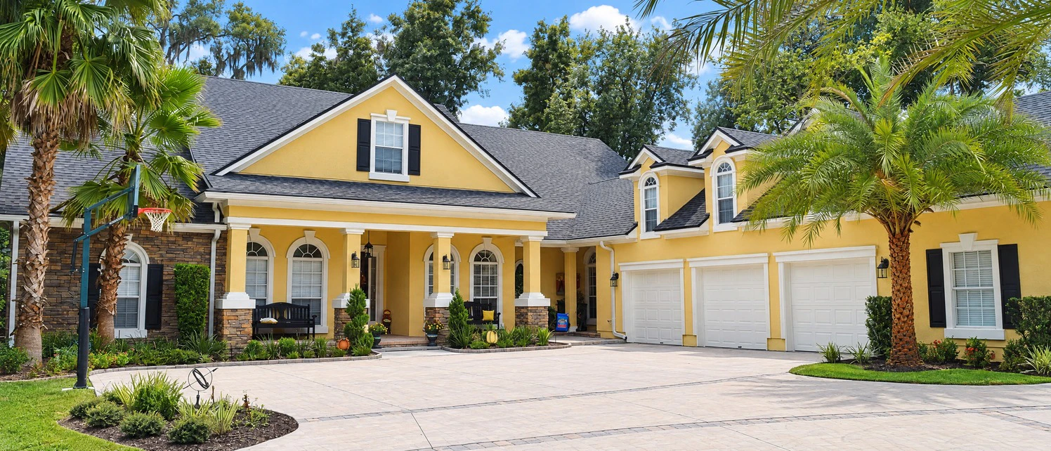 Yellow exterior with three-car garage after repaint in Ponte Vedra Beach, FL