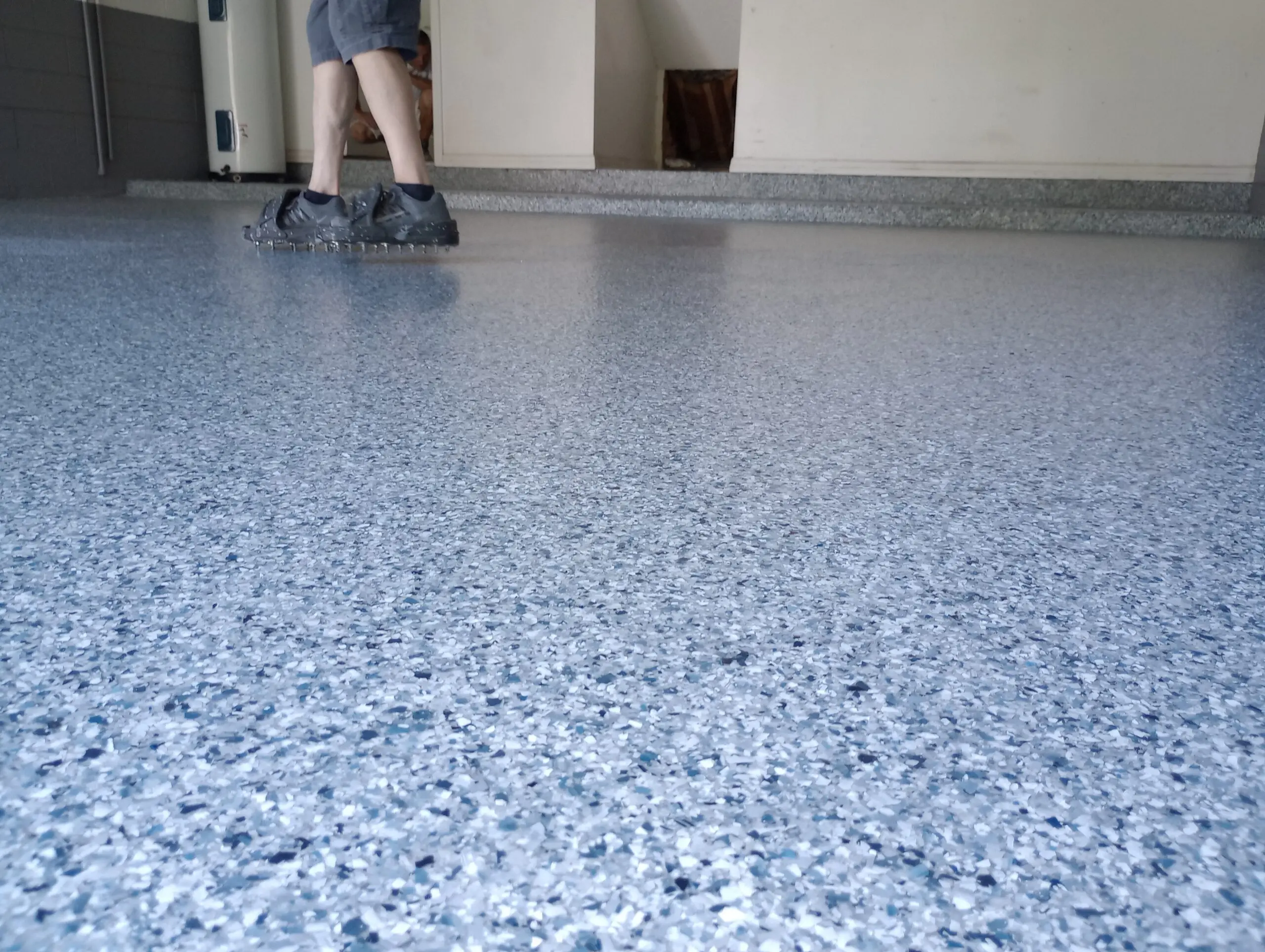 Professional polyurea garage floor coating completed by A New Leaf Painting in Jacksonville, FL — full-broadcast chip system with high-gloss polyaspartic topcoat
