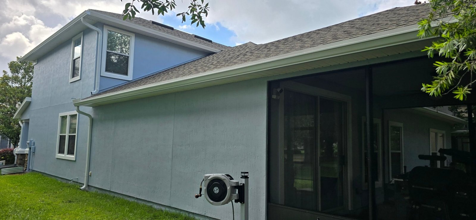 Before and after left elevation of a stucco home with painted bands, trim and fascia in Magnolia Point, Green Cove Springs FL