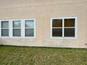 Bulging and loose stucco separating from exterior wall before repair