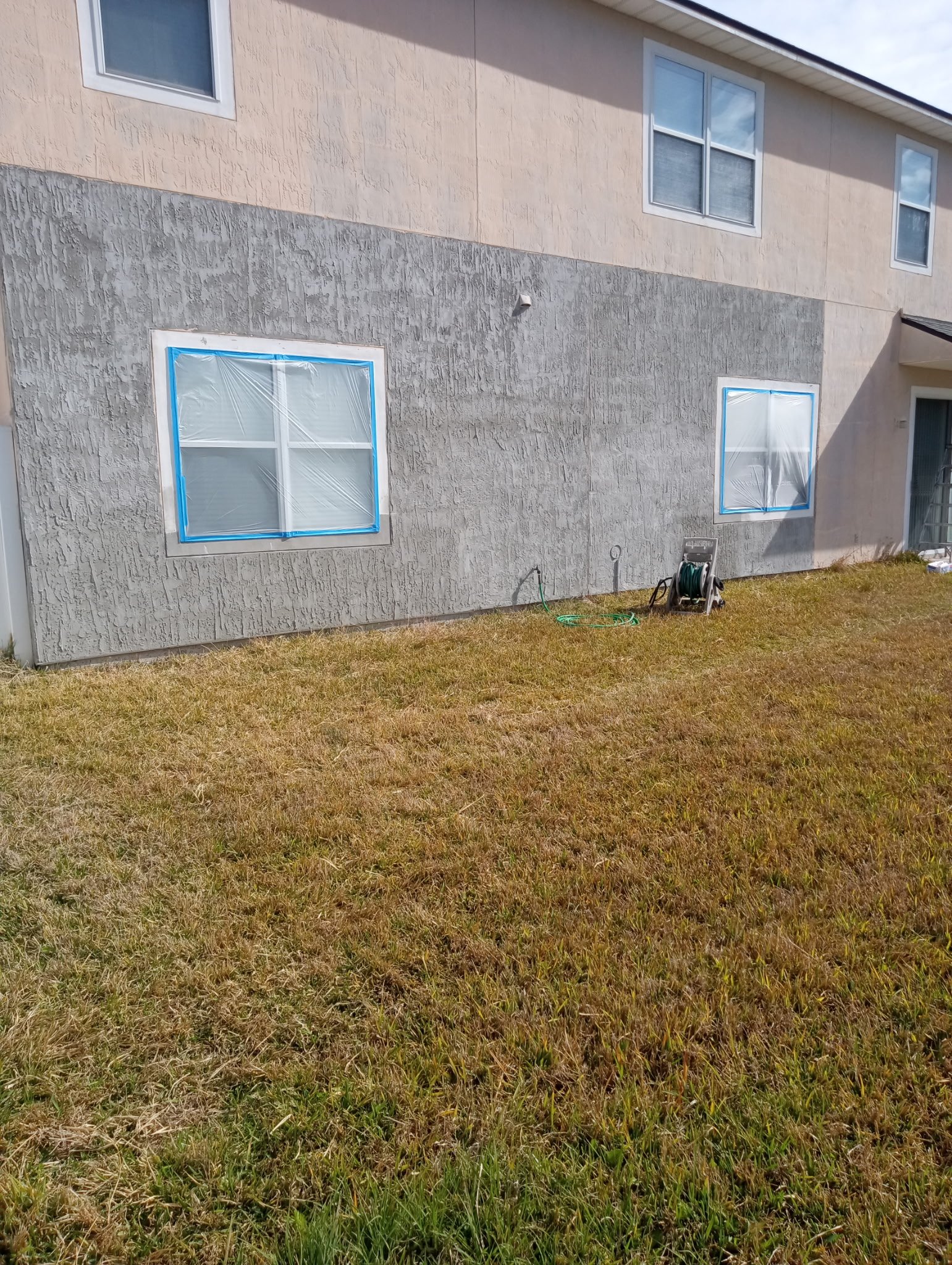 Professional stucco repair underway on a Northeast Florida home