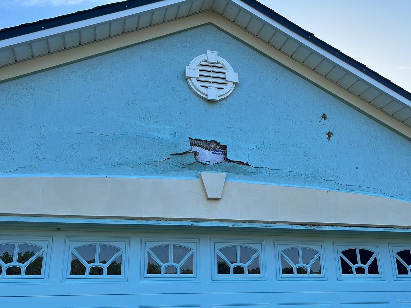 Extensive stucco repair and damaged wall preparation before exterior painting