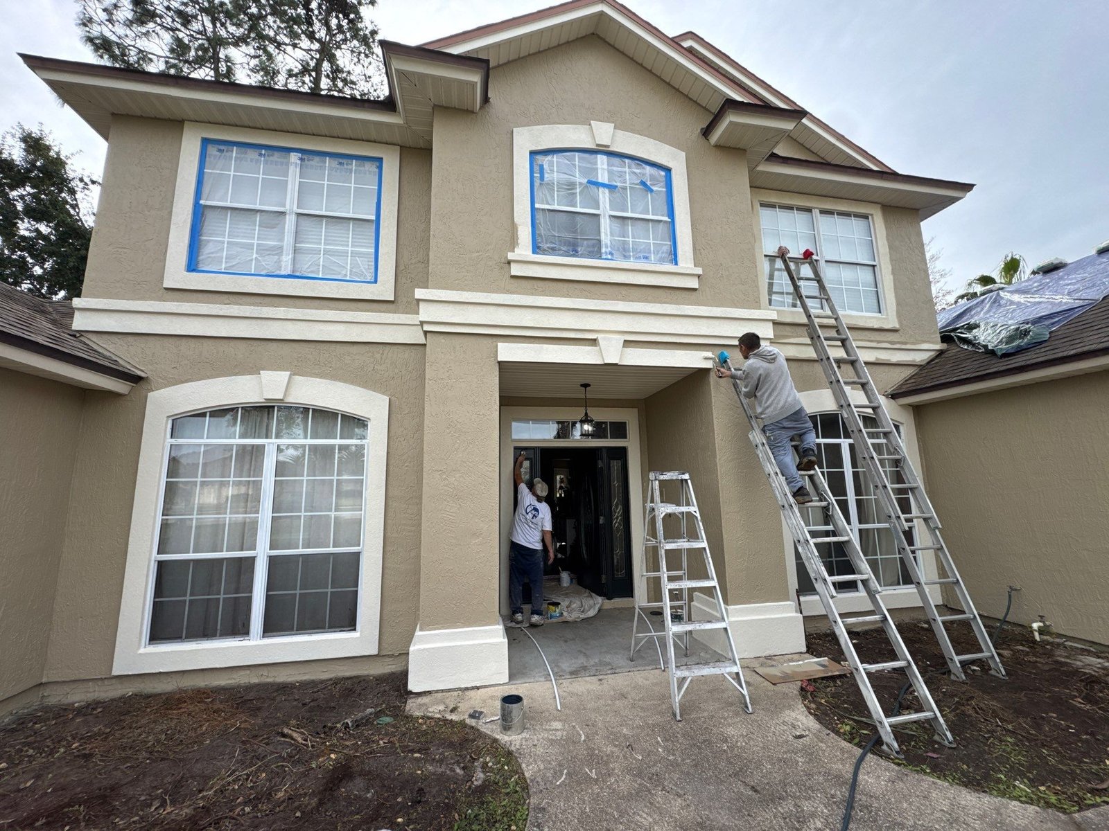 Stucco Exterior Painting Preparation — Eagle Harbor Exterior preparation underway on the front of a stucco home in Eagle Harbor, Fleming Island FL