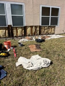 Rotted OSB sheathing exposed after removing delaminated exterior stucco