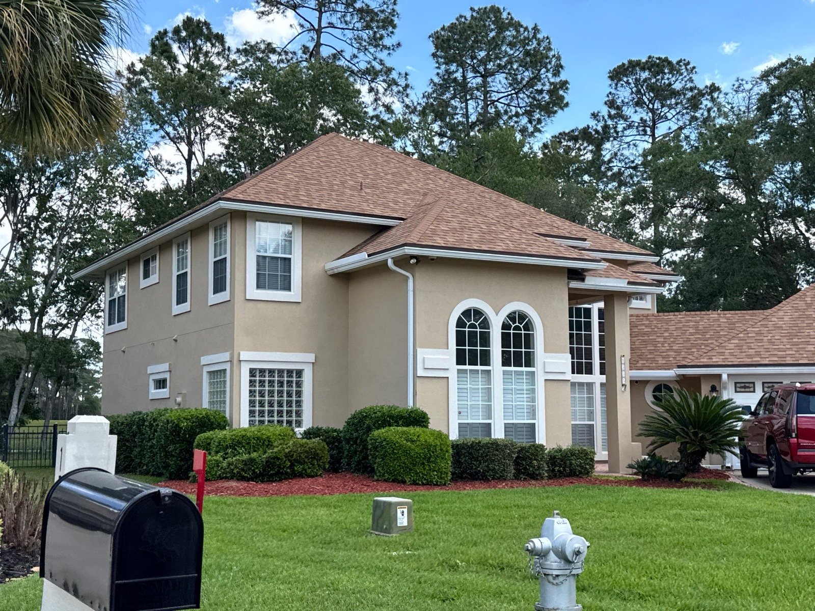 Finished left elevation after synthetic stucco exterior painting in Eagle Harbor, Fleming Island